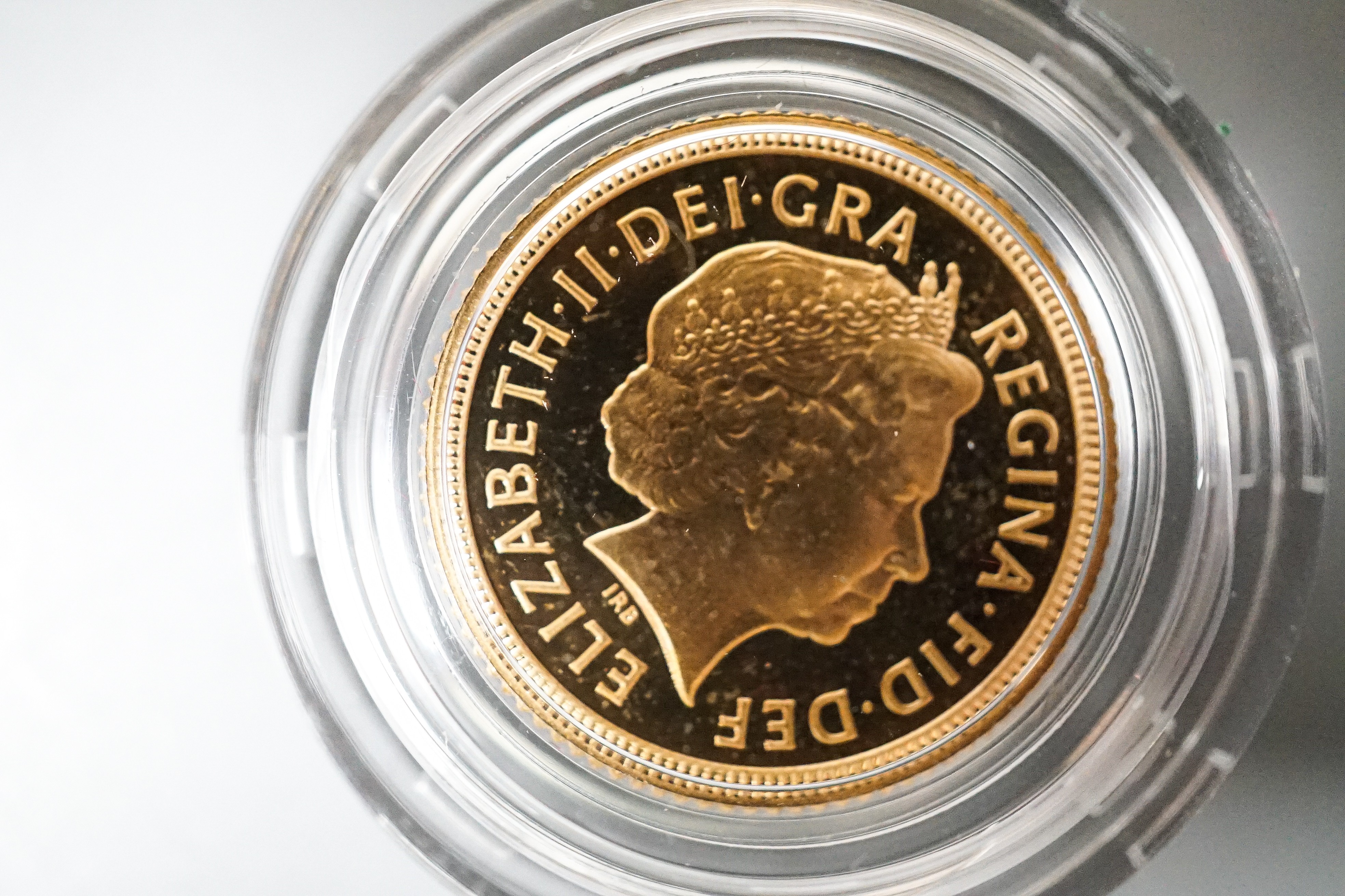 A Royal Mint gold proof sovereign, 2002, cased with certificate and a similar half sovereign (2)